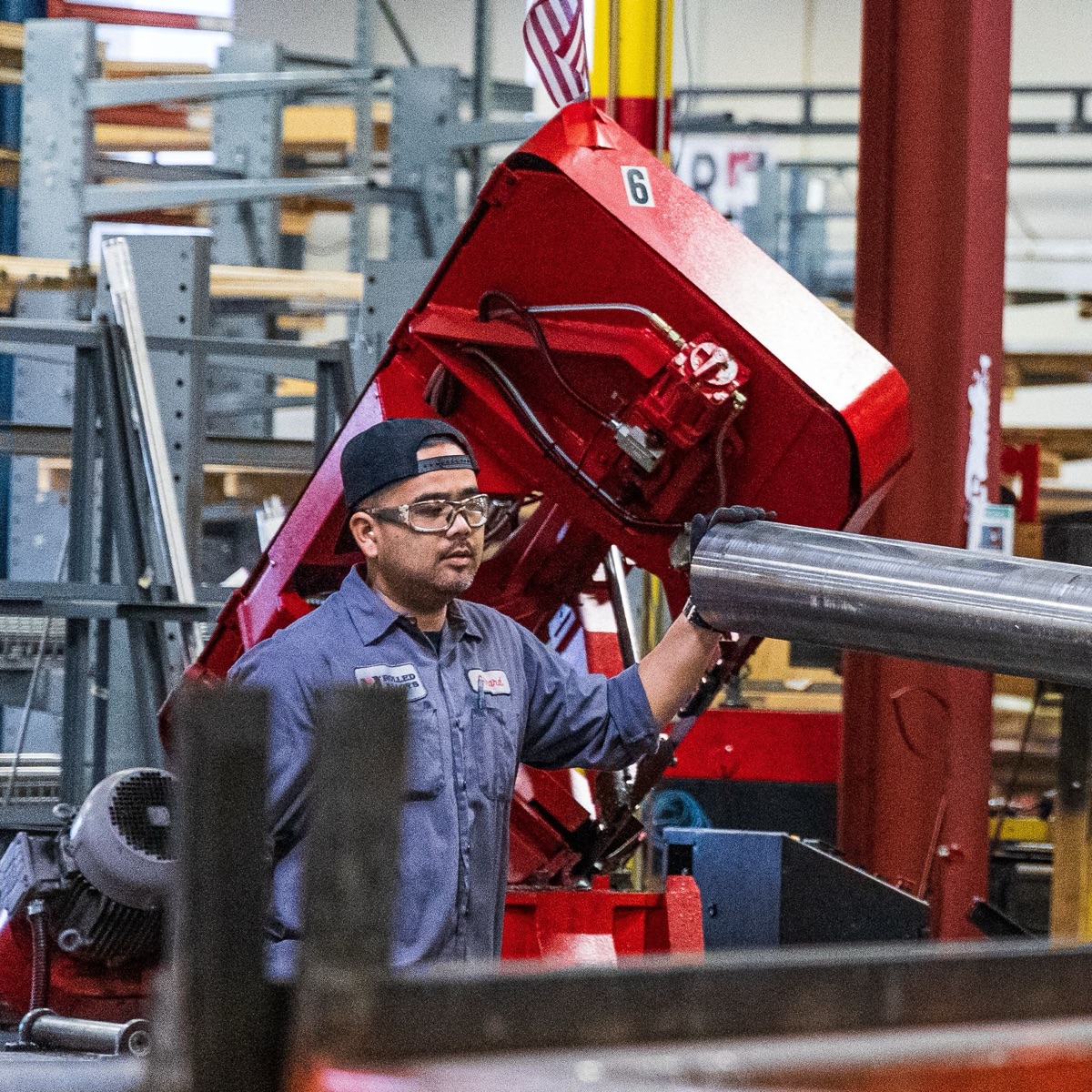 A production associate running equipment on a manufacturing floor